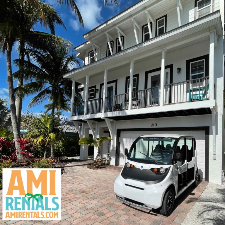 Golf cart rental on Anna Maria Island - 4 passenger Electric GEM car infront of AMI Locals rental home on AMI