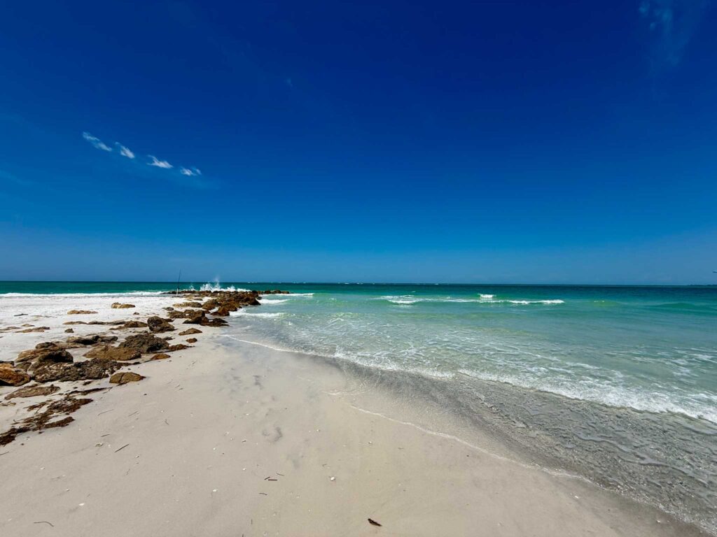 Sunny beach with clear blue water